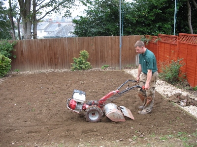 Rotovating the soil in preparation for turf